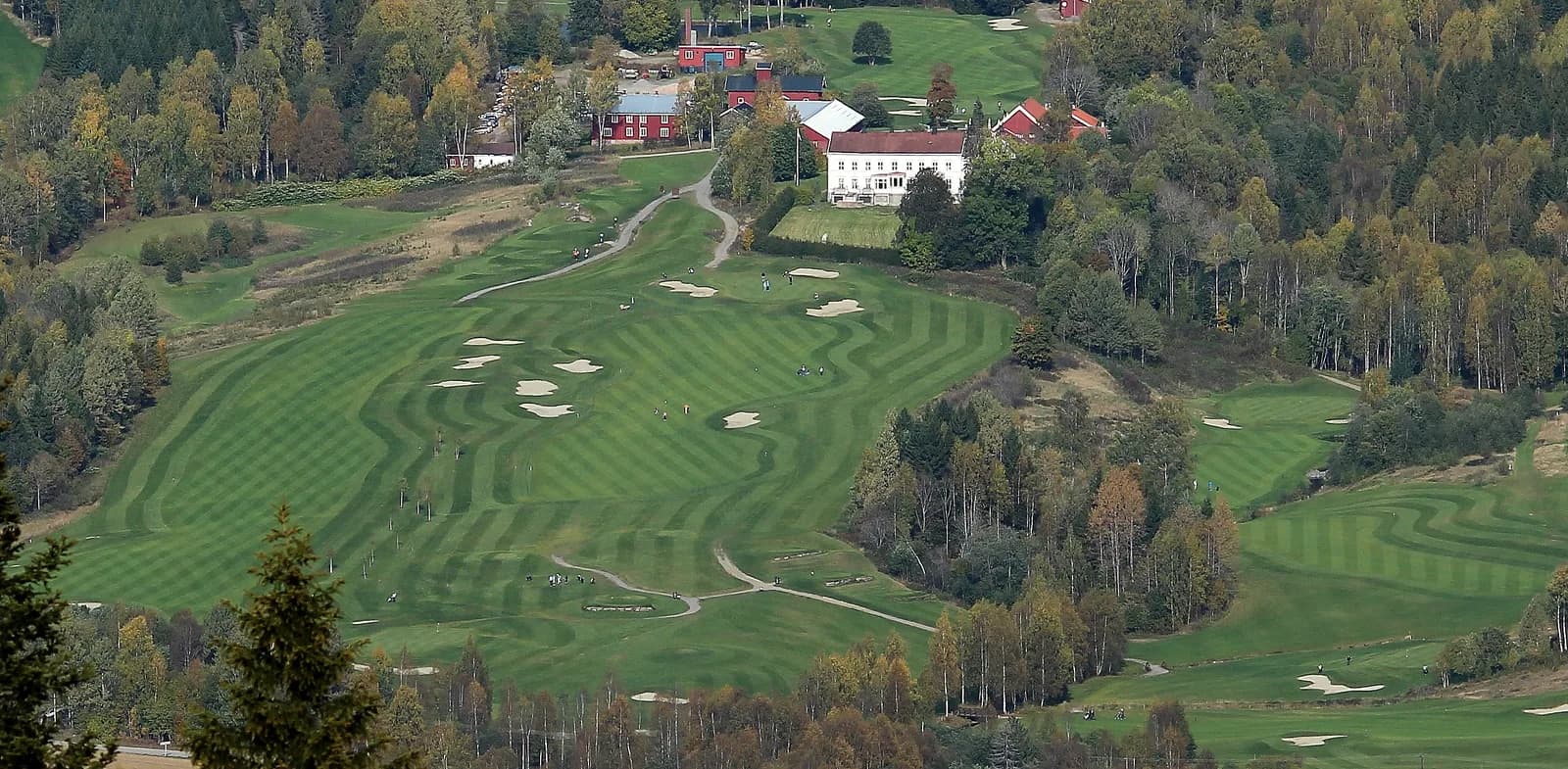 Aerial view of Aas Gaard Golf Park with clubhouse, bunkers and autumn colours in Hakadal