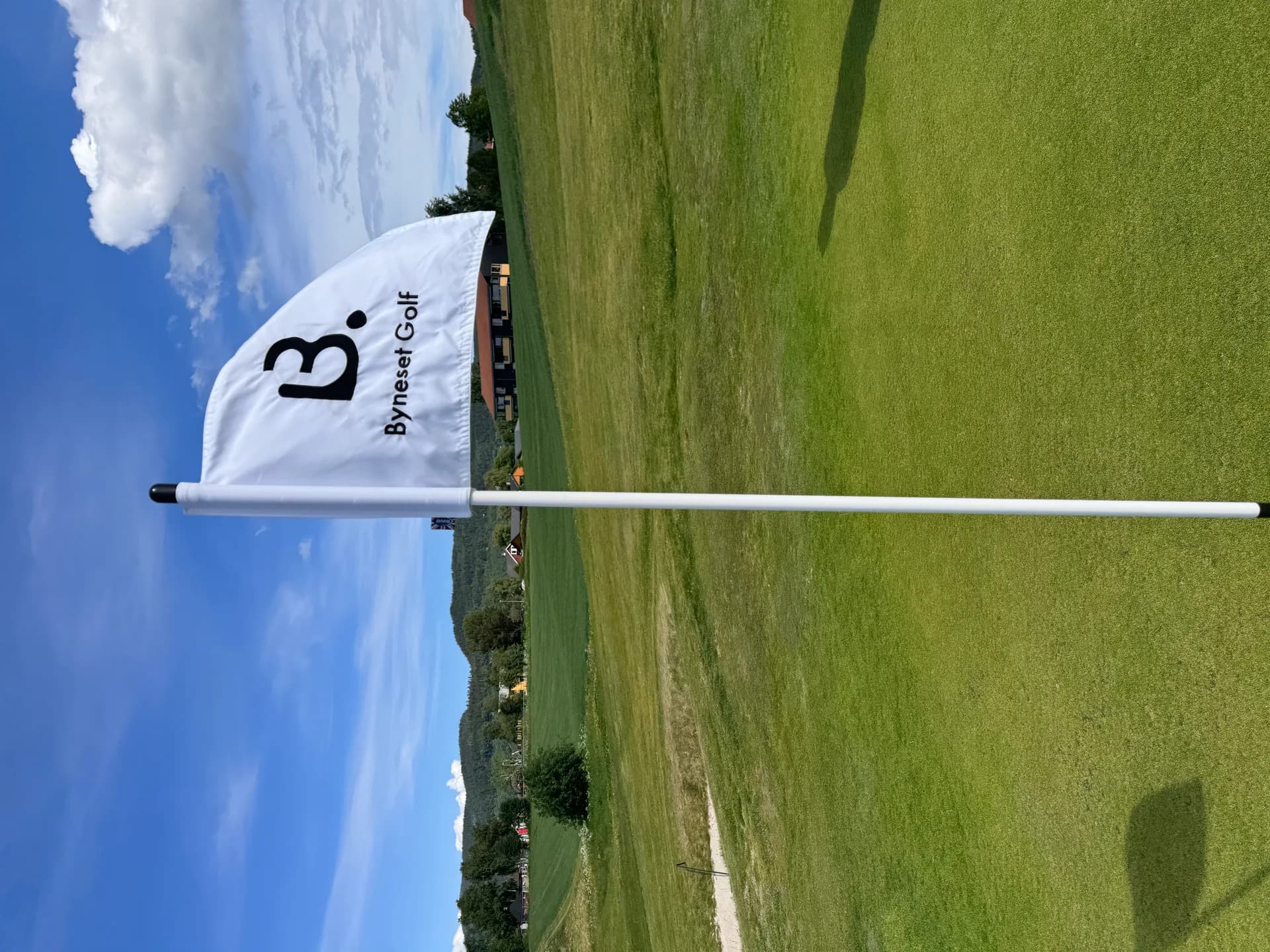 Byneset Golf Club with flag and course area in foreground and background
