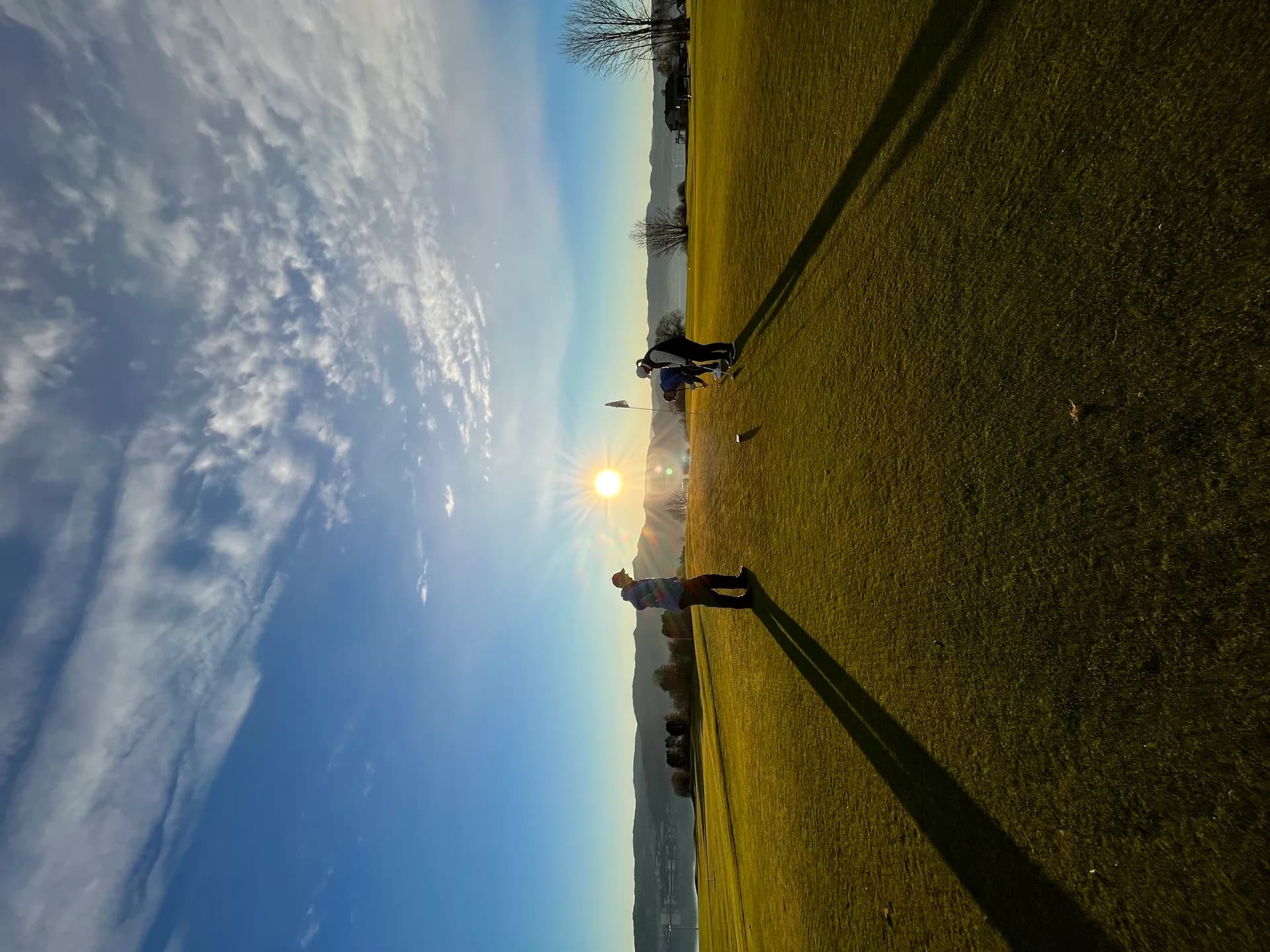 Golfer silhouette against sunset at Byneset Golf Club with open landscape