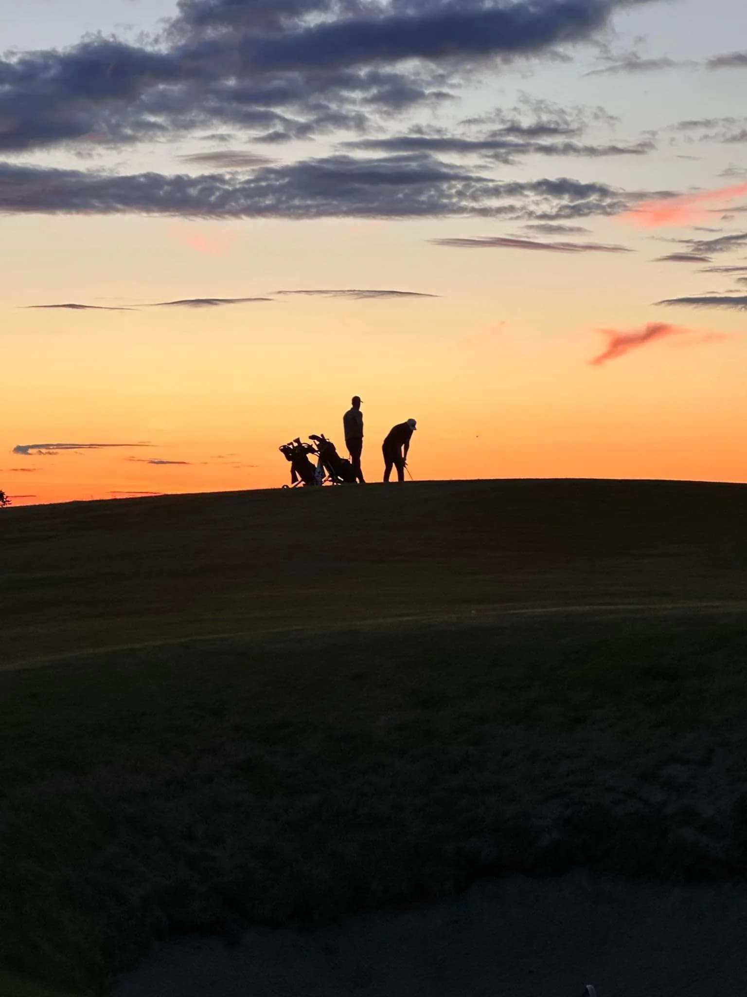 Two golfers on fairway at Byneset Golf Club with open landscape