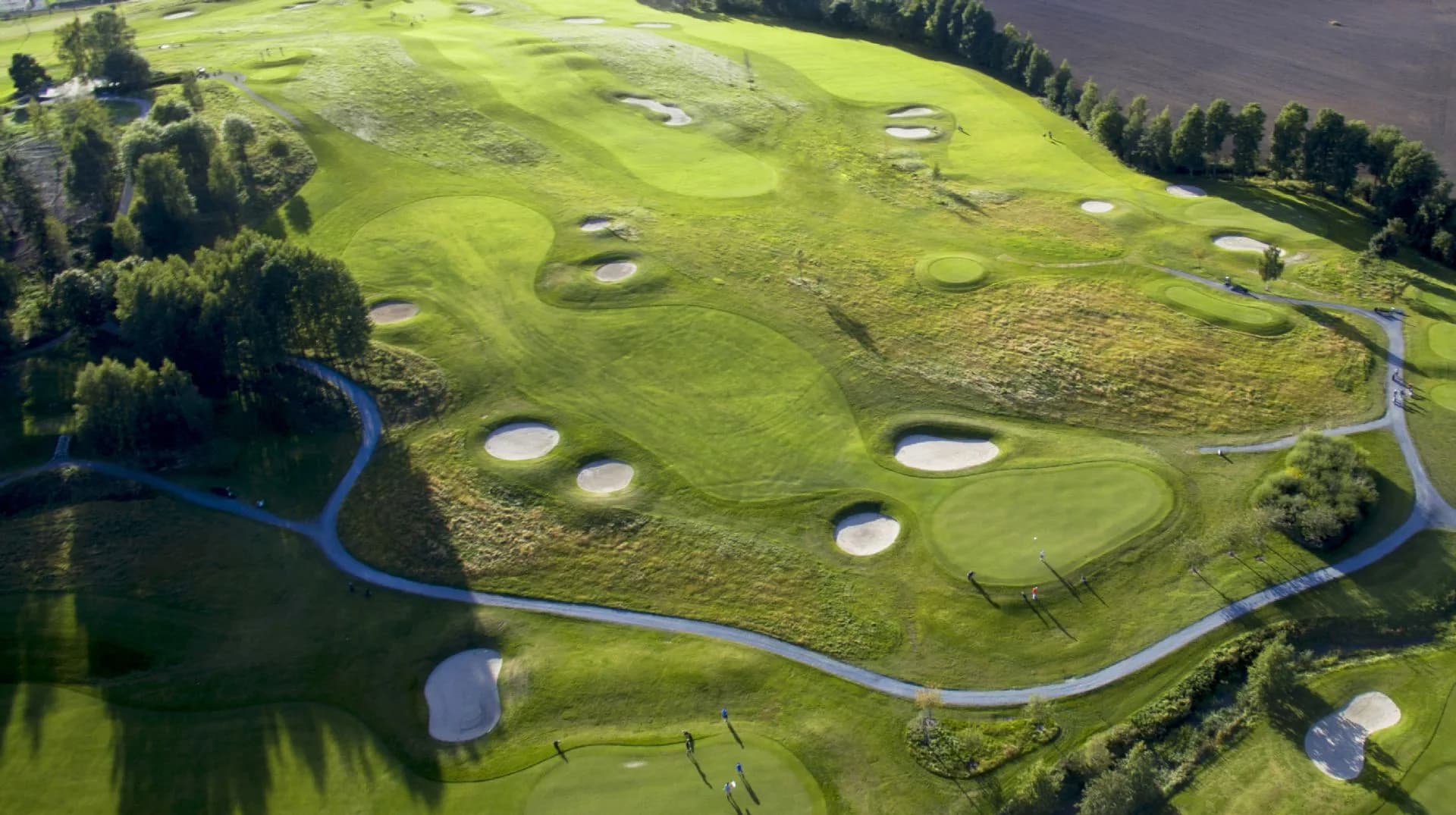 Aerial view of Grini Golf Club's 9-hole golf course with fairways in open terrain