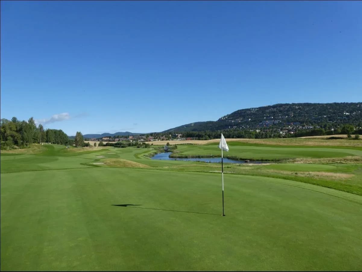 Grini Golf Club clubhouse with surrounding landscape and parking area