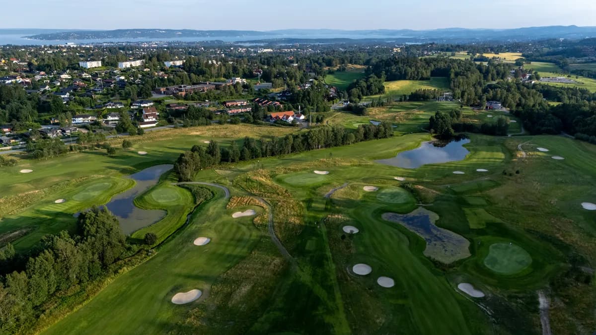 Aerial view of Haga Golf Club with bunkers, water hazards and view towards the Oslo Fjord