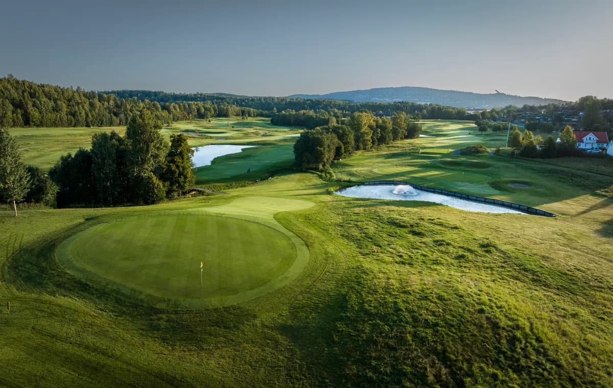 Green with flag and fountain at Haga Golf Club with panoramic view over fairways and water hazards