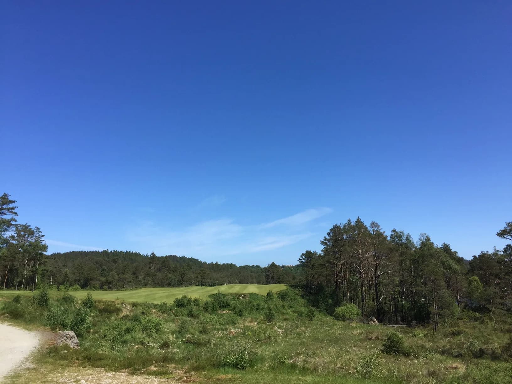 Tee shot from hole 4 at Haugaland Golf Club with wide fairway in Western Norway nature