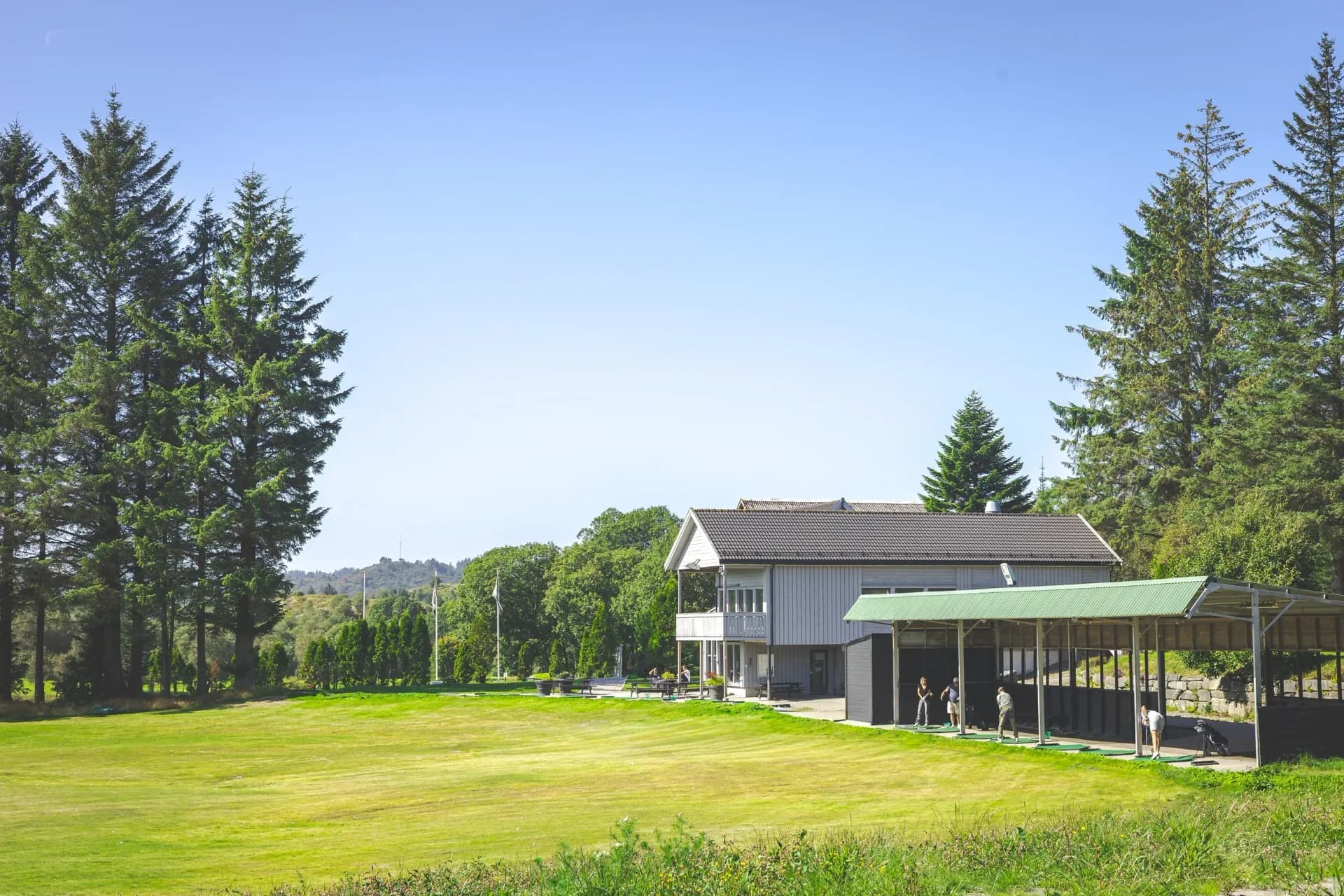 Driving range at Haugesund Golf Club with hitting bays and 240-meter practice area