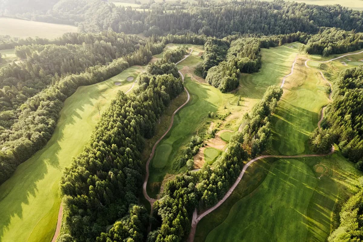 Aerial view of Holtsmark Golf Club with tree-lined fairways, bunkers and ravines in Lier