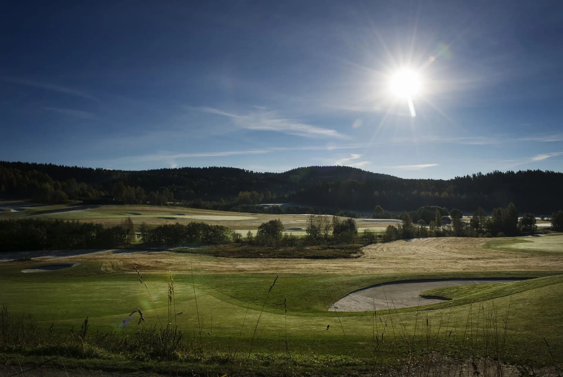 Aerial photo of Losby Golf Club with golf course, fairways and greens in scenic terrain near Finstadjordet