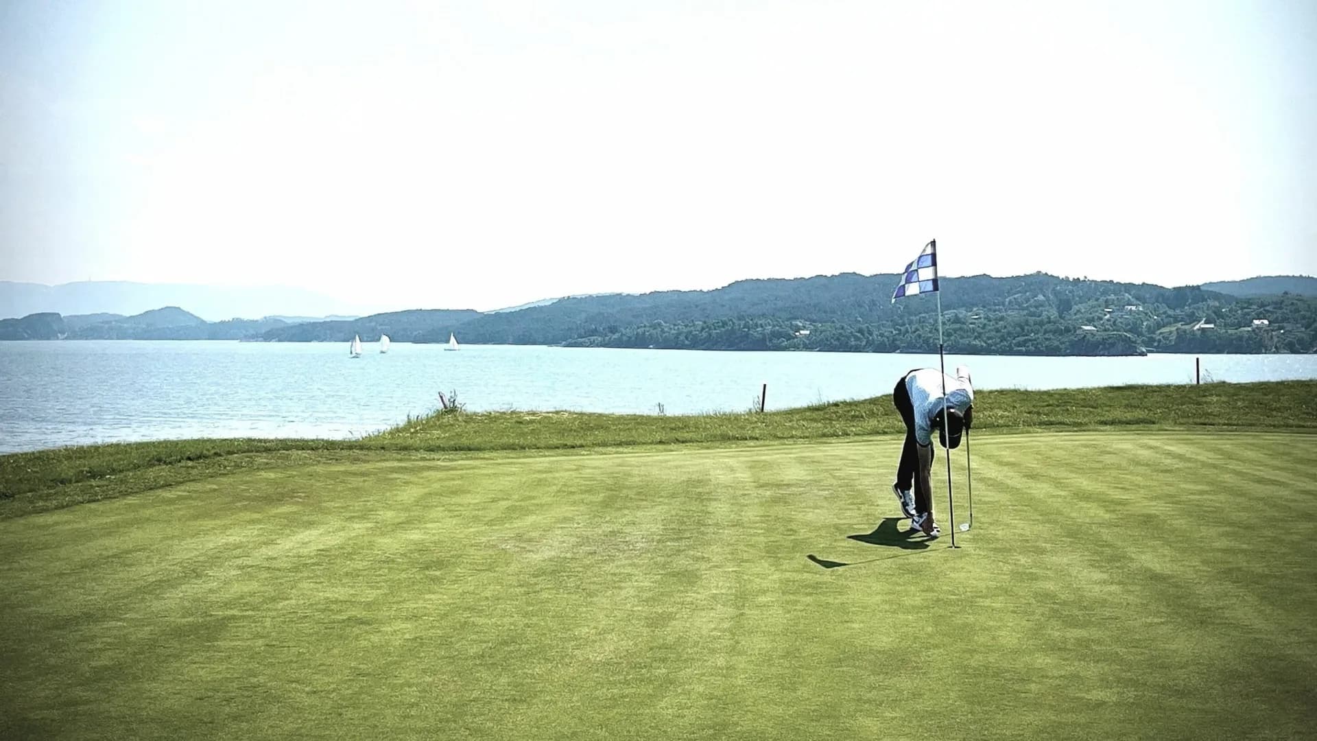 Hole 17 at Meland Golf Club with green and scenic surroundings in western Norwegian nature