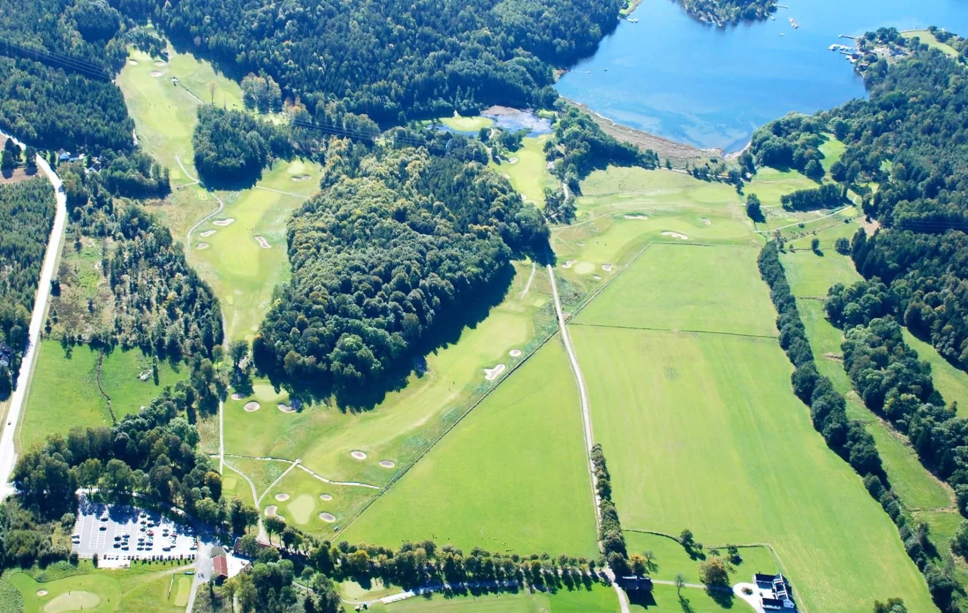Aerial photo of Moss & Rygge Golf Club by Evjesund in the Oslo Fjord with fairways and greens in forested terrain