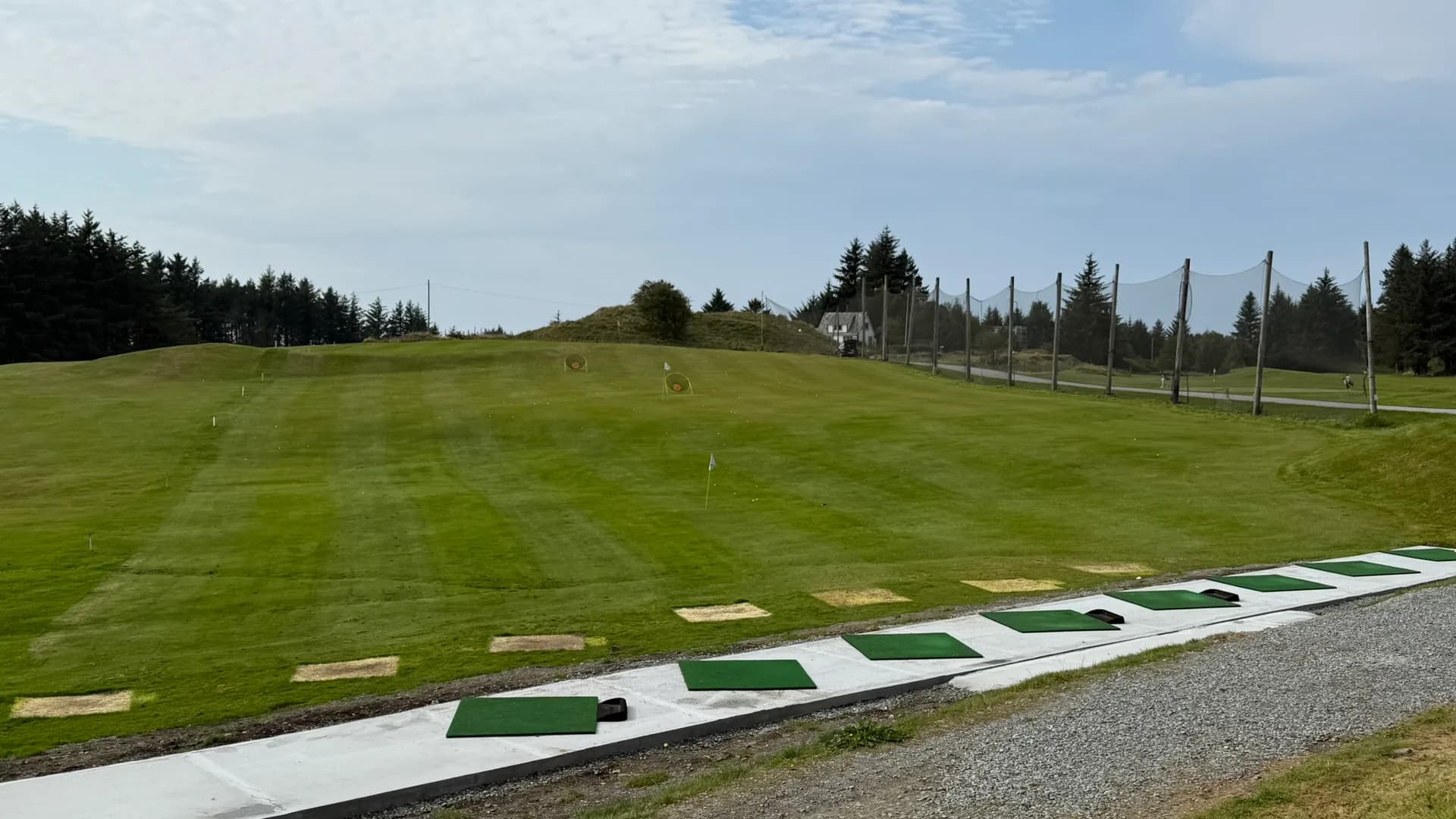 Nordvegen Golf Club's practice area with new concrete pad and fairways in the background