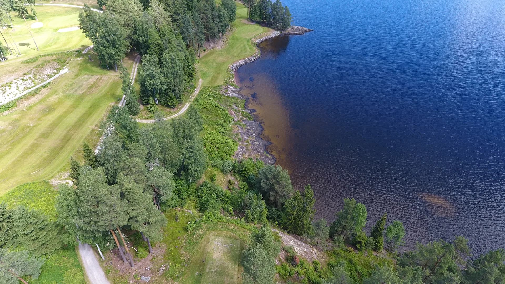 Hole 11 at Norsjø Golf Club from aerial view with fairway through forest terrain