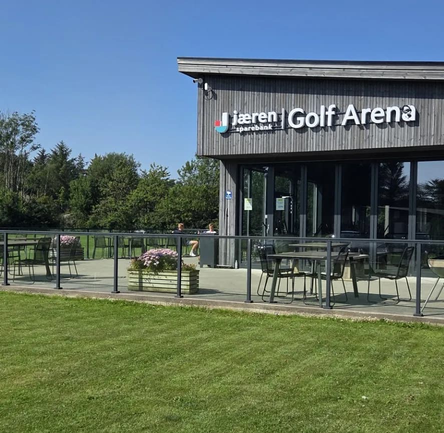 The Jaeren Sparebank Golf Arena clubhouse at Ogna Golf Club with outdoor seating
