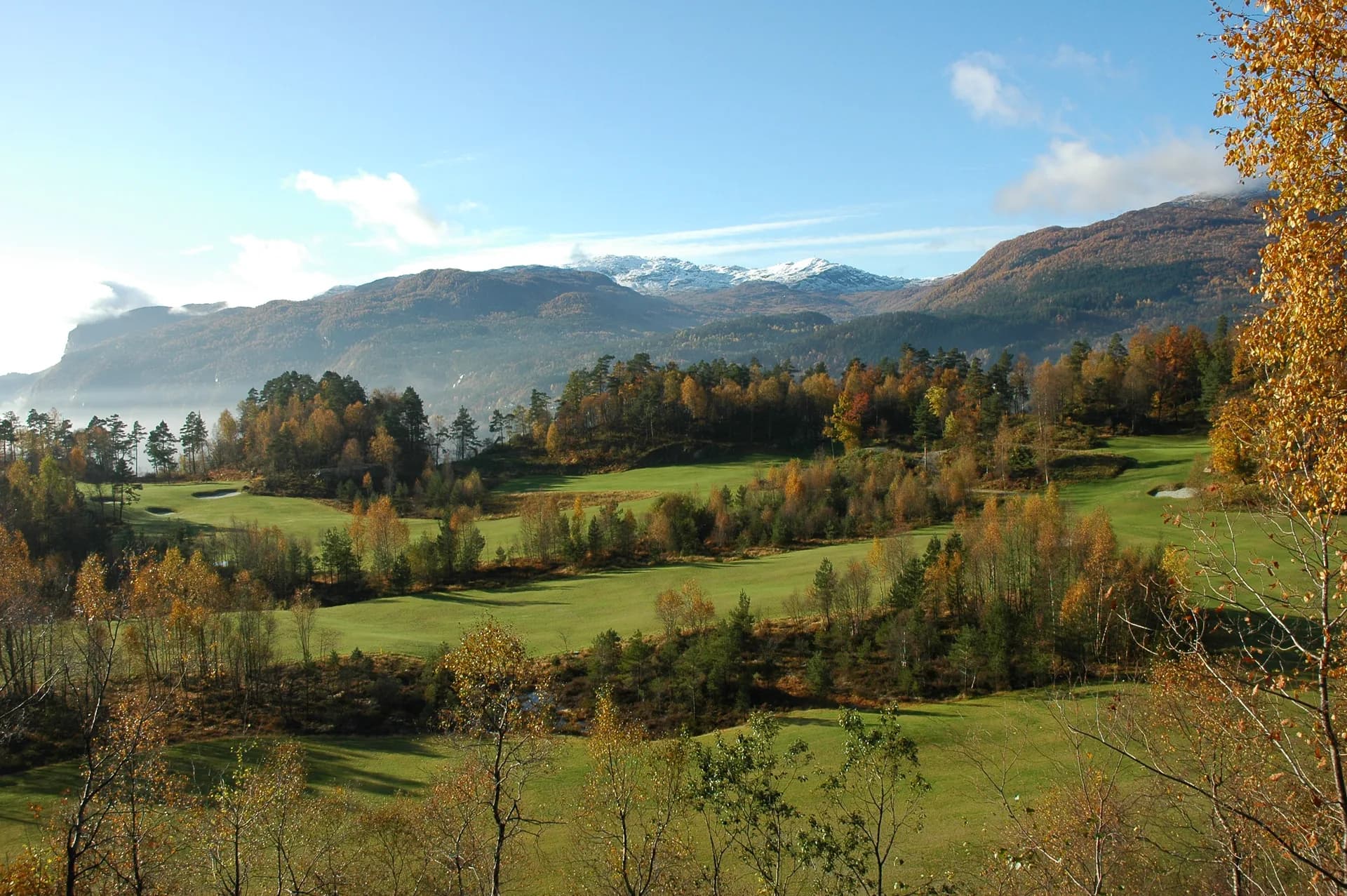 Aerial view of holes 3, 4, 5 and 6 at Sauda Golf Club in hilly forest terrain