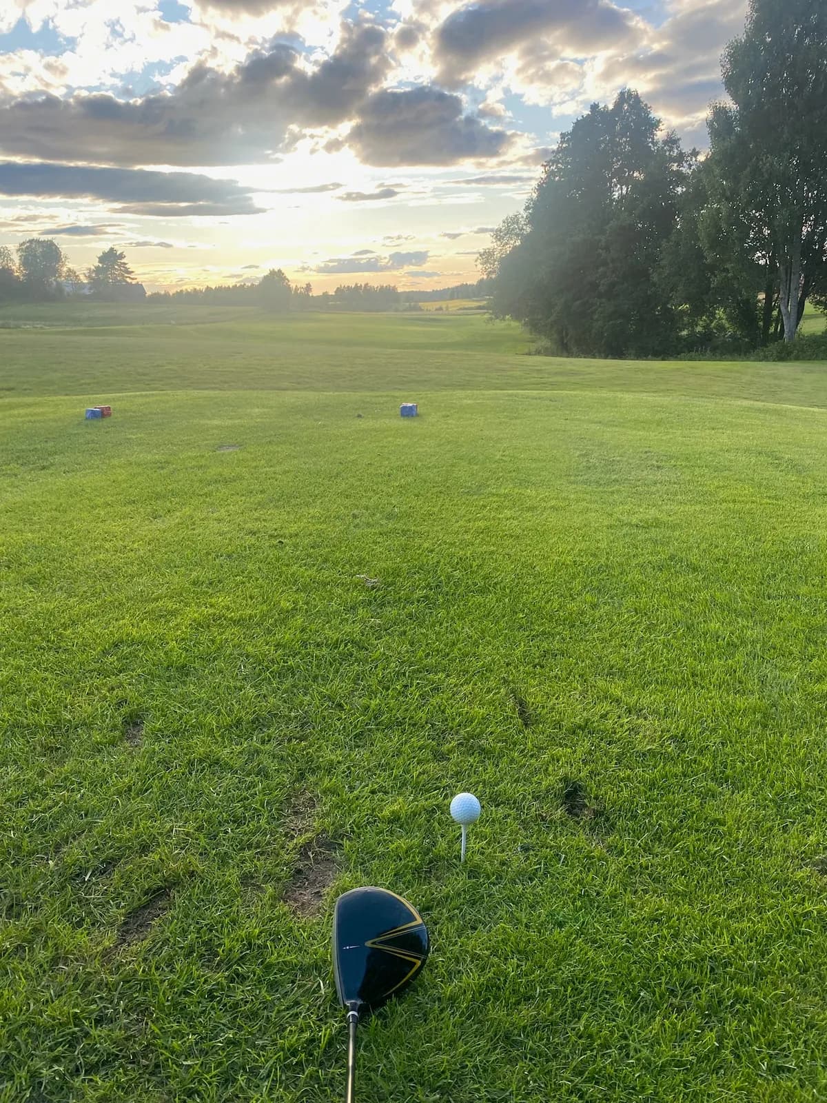 Hole 5 at Ski Golf Club seen from the tee with driver and golf ball in evening light