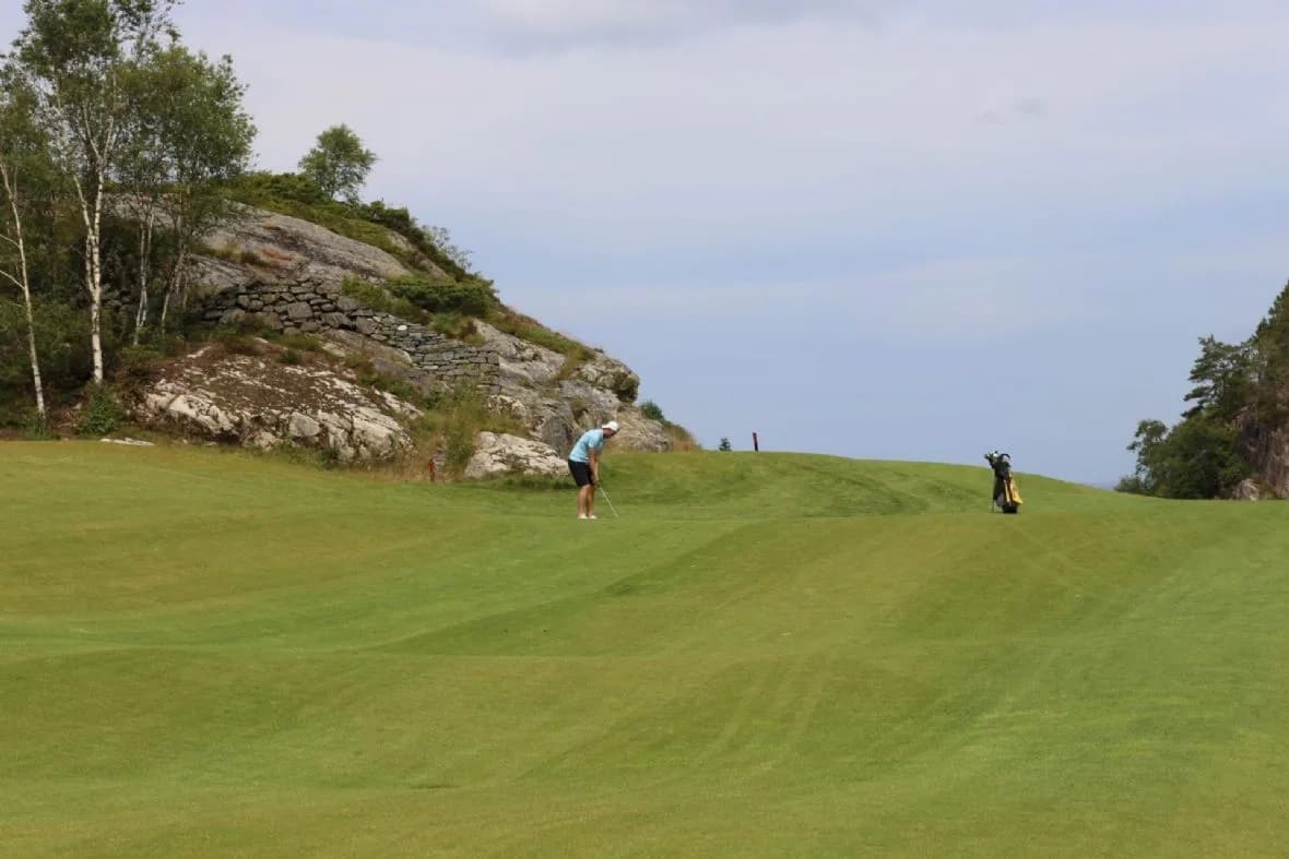 Hole 7 at Sotra Golf Club with fairway through scenic forest terrain