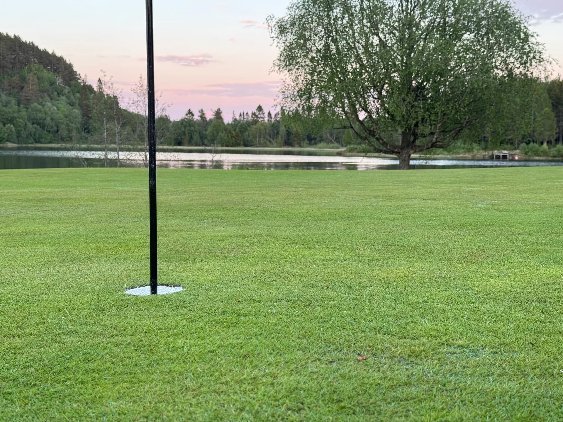 Sunset over Trondheim Golf Club with fairway and green in the foreground