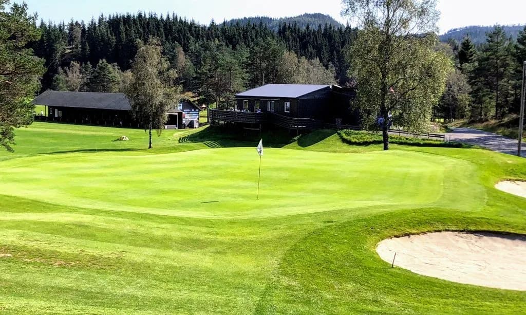 Overview of Utsikten Golf Club with fairways and greens in forest terrain in Kvinesdal